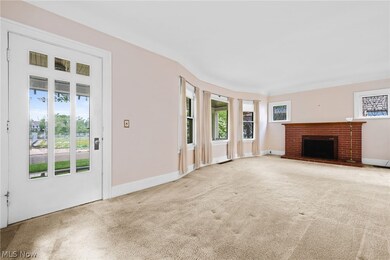 Unfurnished living room featuring carpet, plenty of natural light, and a fireplace