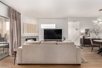 Living room with an inviting chandelier, light woo