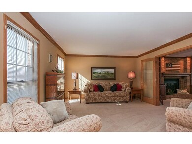 Living room w/ crown molding and French doors to f
