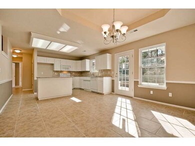 Kitchen. Fresh white cabinets in this open plan kitchen, convenient to living, dining, bedrooms.