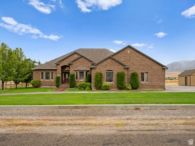 View of front of house with a front yard, brick siding, and a mountain view