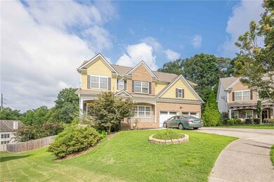 Traditional-style home featuring driveway, brick siding, a garage, and covered porch