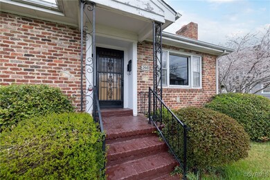 Doorway to property featuring brick siding and a c