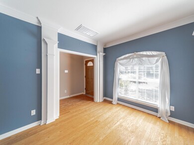 Spare room with ornamental molding, light hardwood