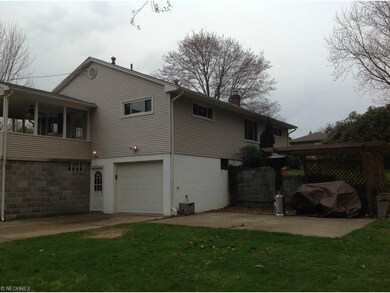 Back corner, covered porch with ceiling fan, back 