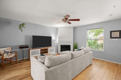 Living area featuring baseboards, a ceiling fan, 
