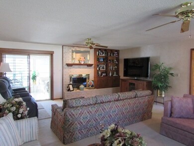 The living room also has a fireplace that has a ga