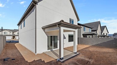 Rear view of house featuring a fenced backyard, a residential view, stucco siding, and a patio