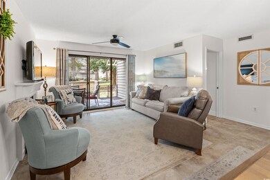 Living room featuring a ceiling fan and baseboards