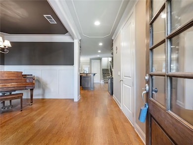 Hall with light hardwood / wood-style floors, crow