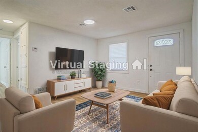 Living area featuring visible vents, baseboards, a