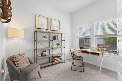 Carpeted office space featuring baseboards