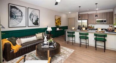Living room with light wood-style floors, wainscoting, recessed lighting, and a decorative wall