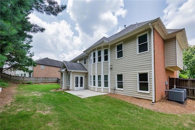 Rear view of property with a patio area, french doors, cooling unit, and brick siding