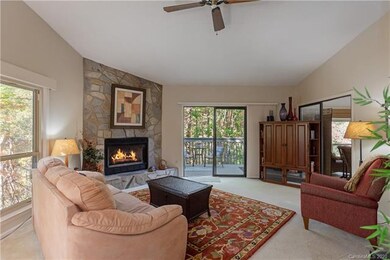 Comfy living room with fireplace. Sunroom is to th