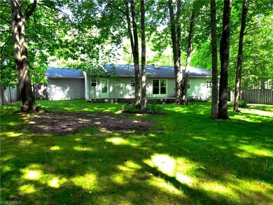 Rear view of house from inside the completely fenc