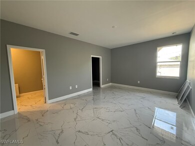 Unfurnished room with baseboards and light marble
