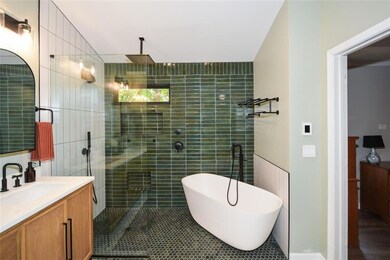 Spa-like Master Bath features glass enclosed shower, freestanding soaking tub, double vanity and HEATED floors!