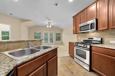 Kitchen featuring appliances with stainless steel