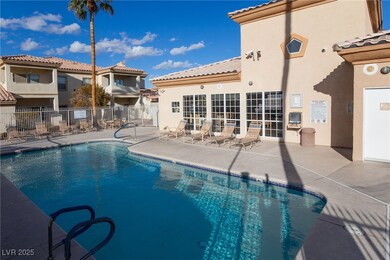 Community pool with french doors, a patio area, an