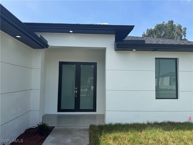 Entrance to property with roof with shingles, stuc