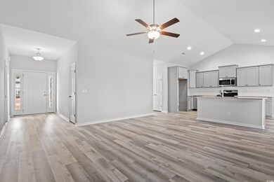 Unfurnished living room featuring ceiling fan, lig