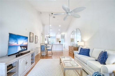 Living area featuring visible vents, light wood fi