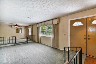 Spacious sunken living room beside dining room. 