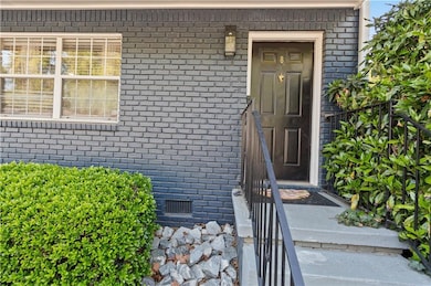 Doorway to property with brick siding and crawl sp