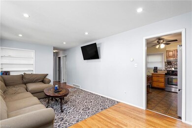 Hardwood floored living room featuring built in sh