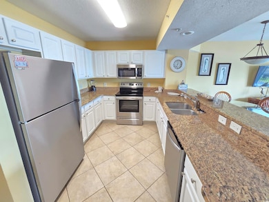 Kitchen featuring light tile patterned floors, a p