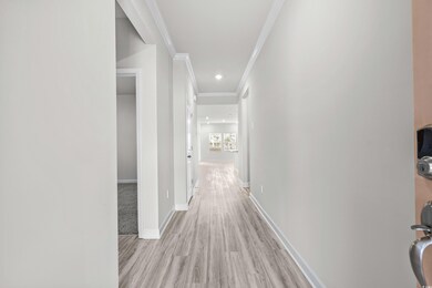 Hall with light hardwood / wood-style flooring and