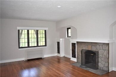 Living Room with Refinished Hardwood Floor & Stone