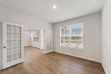 Unfurnished room with french doors, baseboards, an