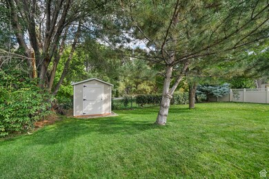 Fenced backyard with a shed