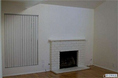 Cozy fireplace in family room has cathedral ceilin