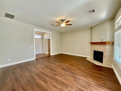 Unfurnished living room featuring ceiling fan, a t