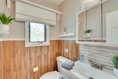 Half bathroom with toilet and a sink