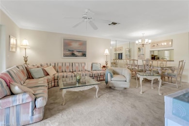Carpeted living room featuring visible vents, crow