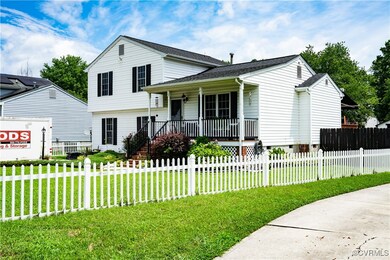 Split level home featuring covered porch, a fenced