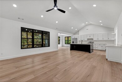 The living space, kitchen, dining, and deck make for a welcoming space for your guests.