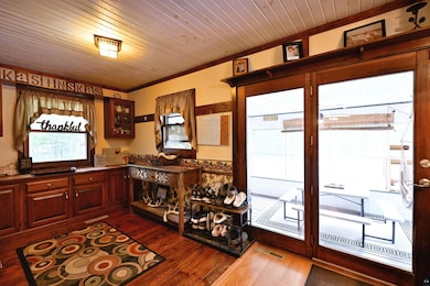 Office with dark wood-style floors, crown molding, and wooden ceiling