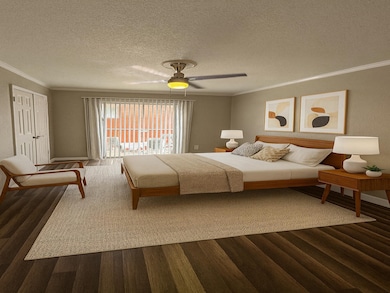 Bedroom with a textured ceiling, ornamental molding, wood finished floors, and ceiling fan