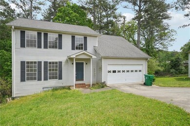 Colonial inspired home featuring concrete driveway