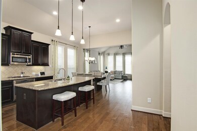 Spacious island kitchen opens to dining a living room.