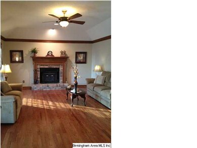 Hardwoods in over-sized great room with crown molding.