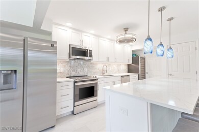 Kitchen features stainless appliances, quartz coun