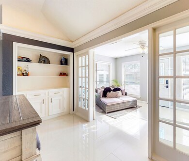 The built-ins still have the plumbing to be transformed into a wet bar. The French doors lead you to the sun room, and back yard pool.