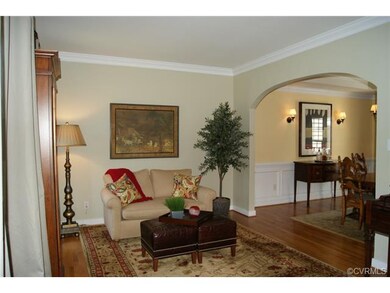 Looking into dining room via oversized arched open