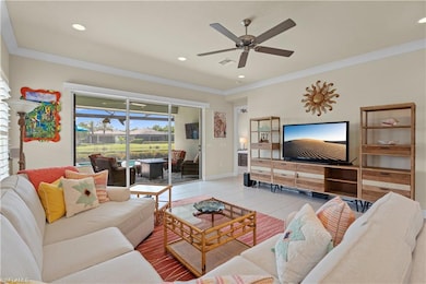 Living room with crown molding, tile patterned flooring, a ceiling fan, and recessed lighting